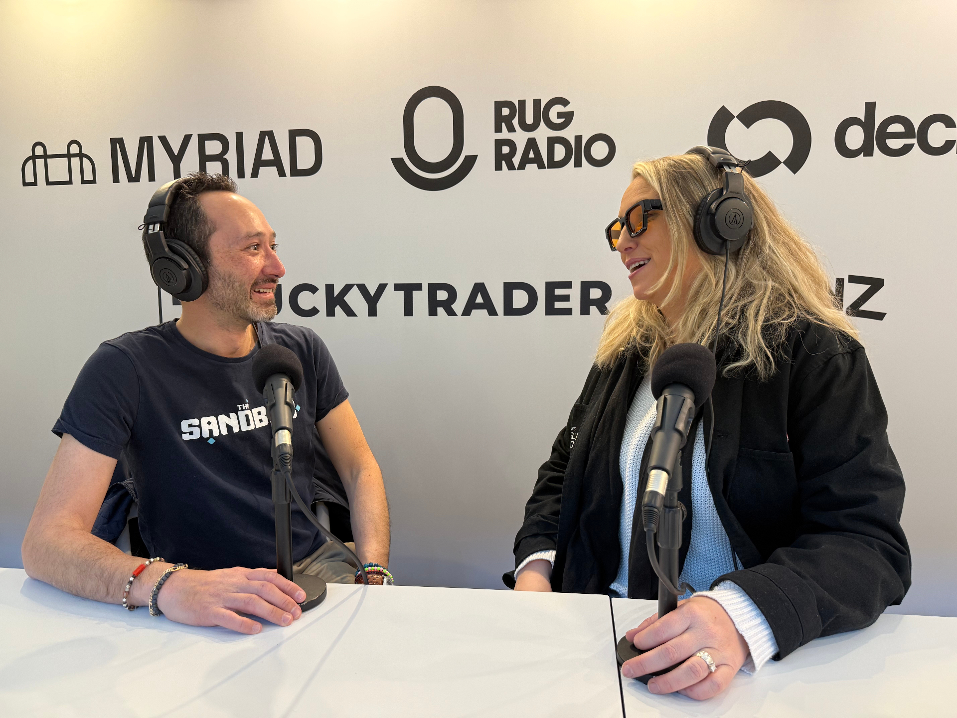 Good News Studio podcast interview on a branded media wall